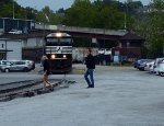 Pedestrians cross the NS "Old Main Line" in front of a stopped E19 yard job.